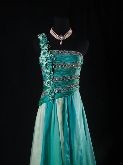 Robe de bal longue sans manches, coupe trapèze, style rétro années 60/70, multicolore (vert et bleu), ornée de perles et de pierres précieuses. Référence AS147.
