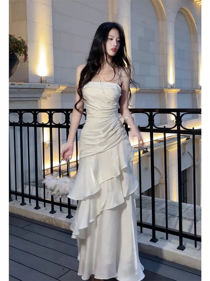 Robe de bal longue blanche à fines bretelles spaghetti et volants, style sirène, idéale pour les lycéennes, les jeunes filles et les jeunes filles. Parfaite pour une soirée de fin d'année ou un anniversaire (20 ans). Référence : AB2503